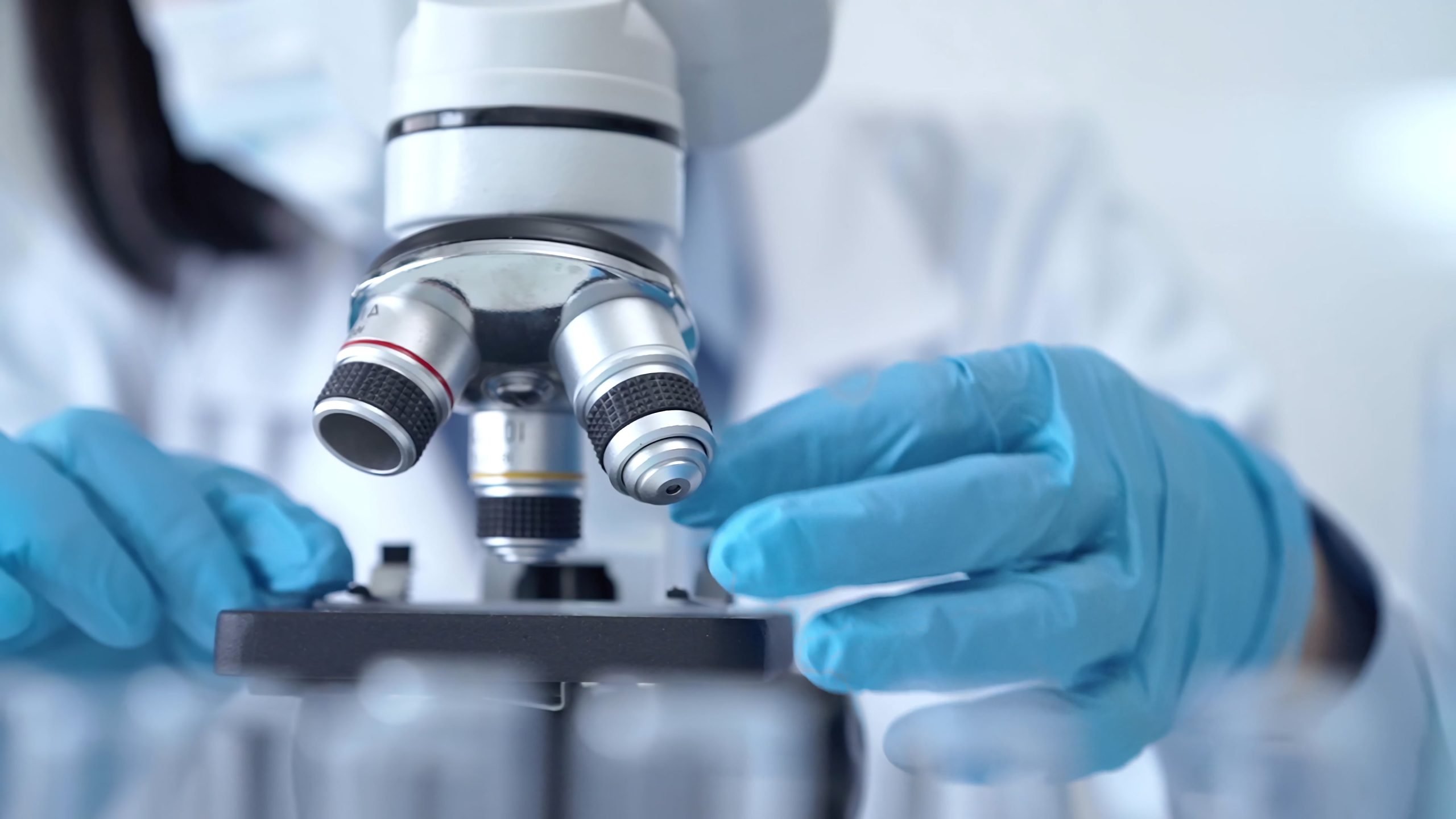 Scientist using microscope in laboratory